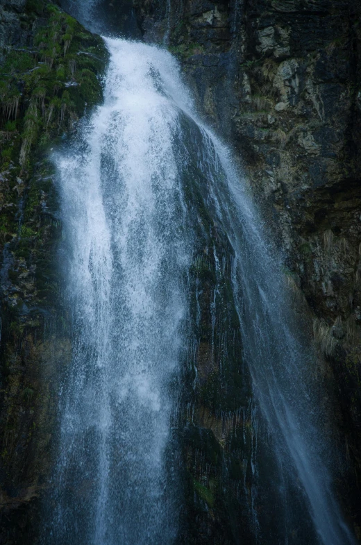 a large waterfall coming off the side of a cliff