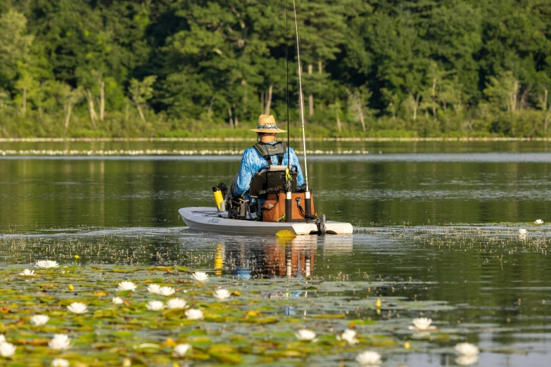 there is a man sitting in a small boat on the water