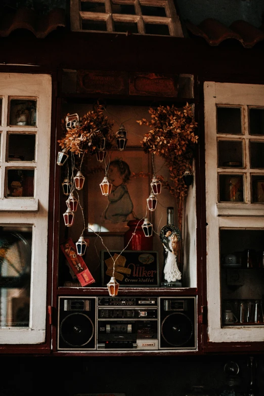 an old fashioned stereo with potted plants and other things in the background