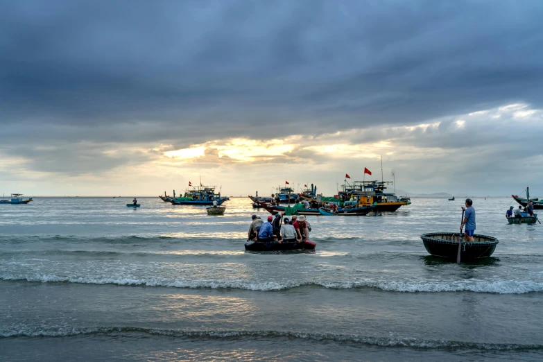 several boats on the water with cloudy skies above