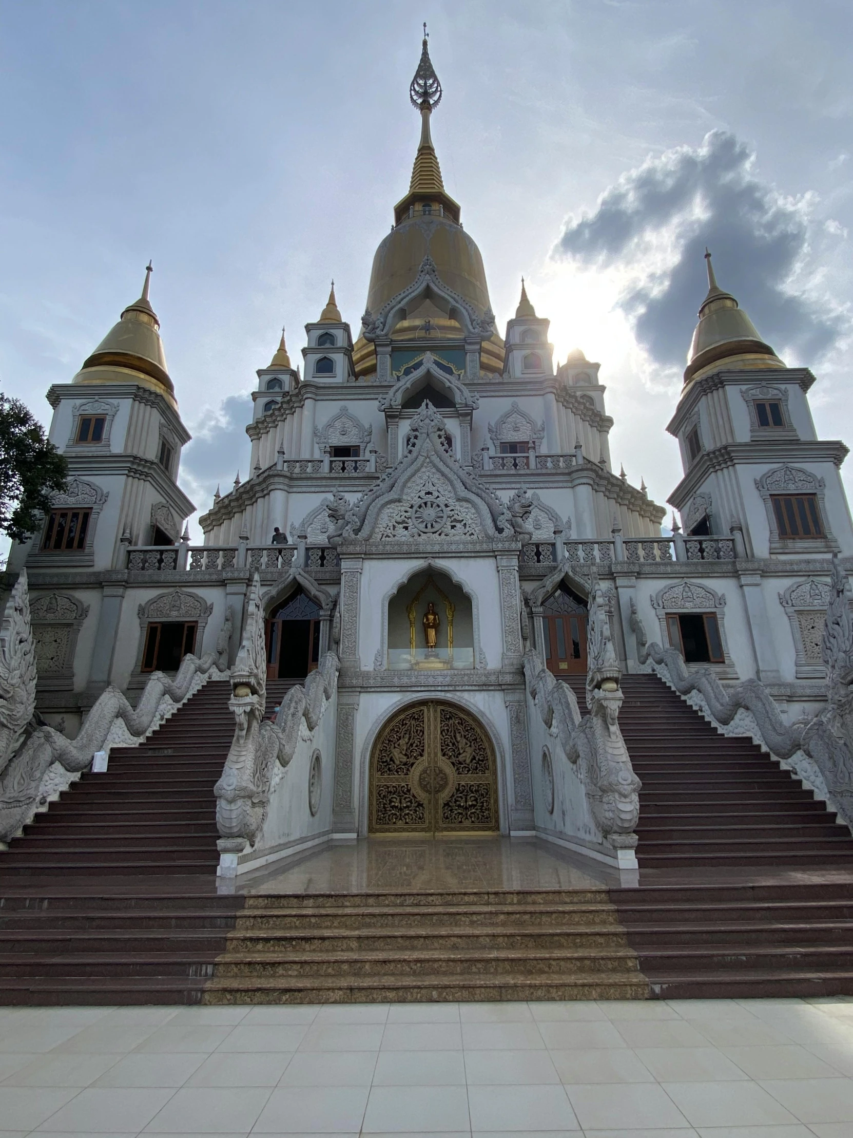 a very ornate white and gold church with some stairs