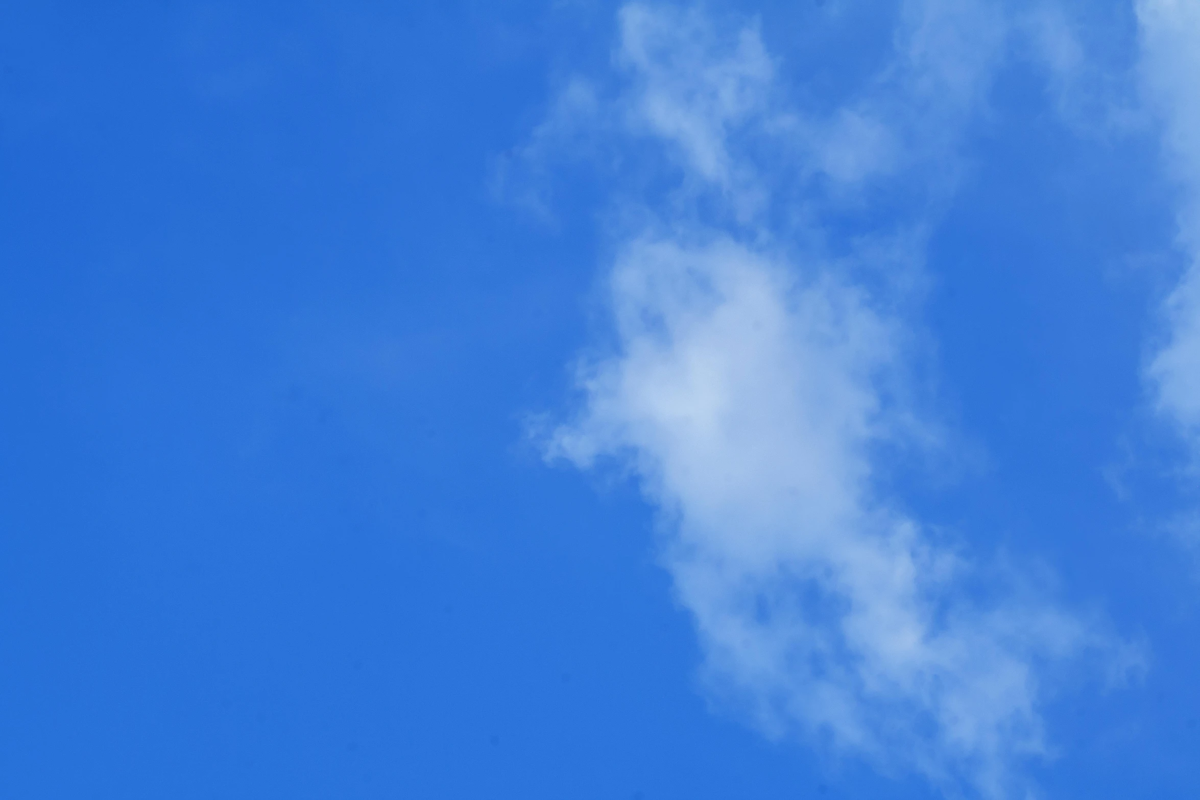 airplane flying high into a cloudless sky