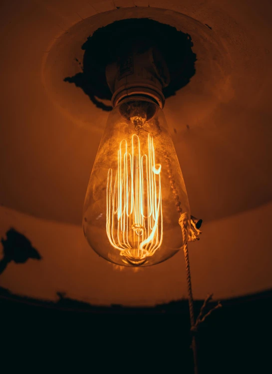 a light bulb turned on with a wire underneath