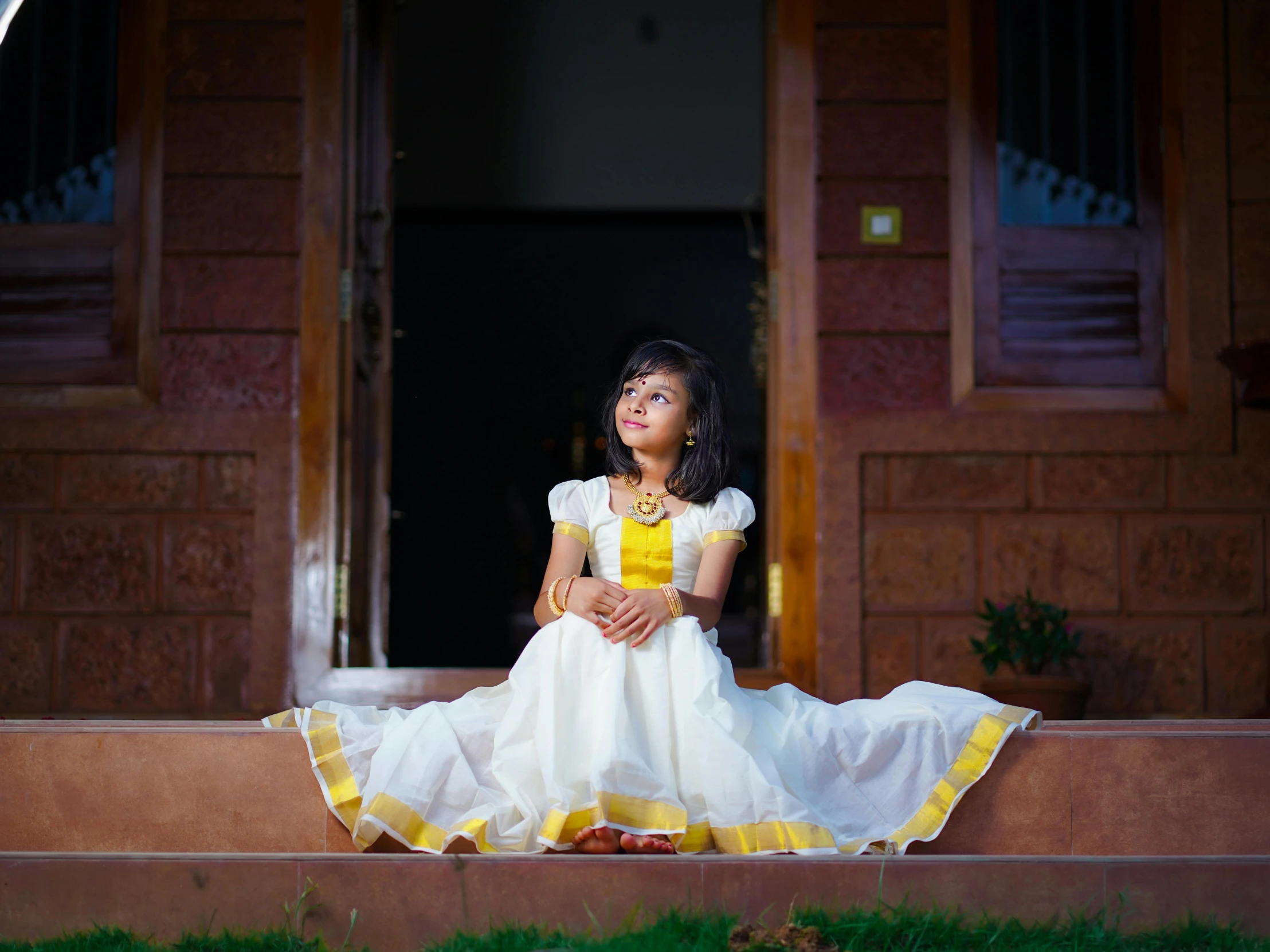 a little girl that is sitting on the steps