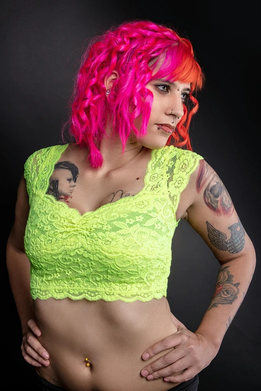 a girl with pink hair and tattoos on her chest