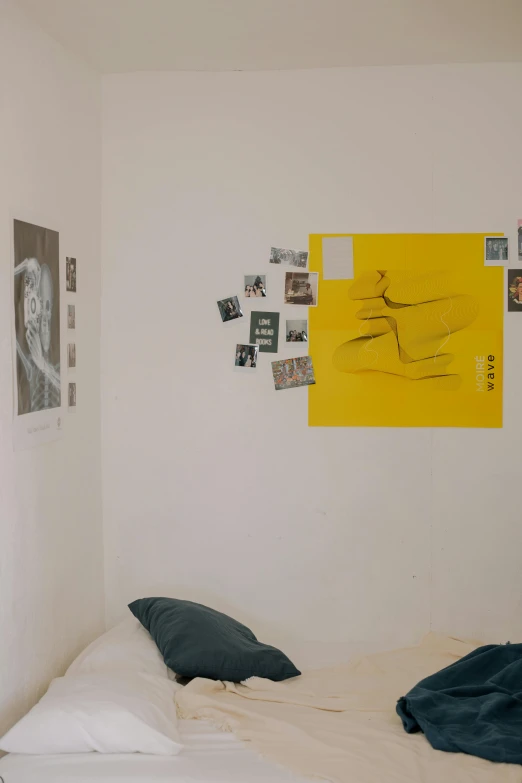 the yellow poster is hung up on the white wall