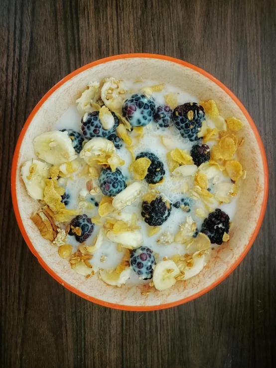 a bowl filled with cereal and berries on top of a table