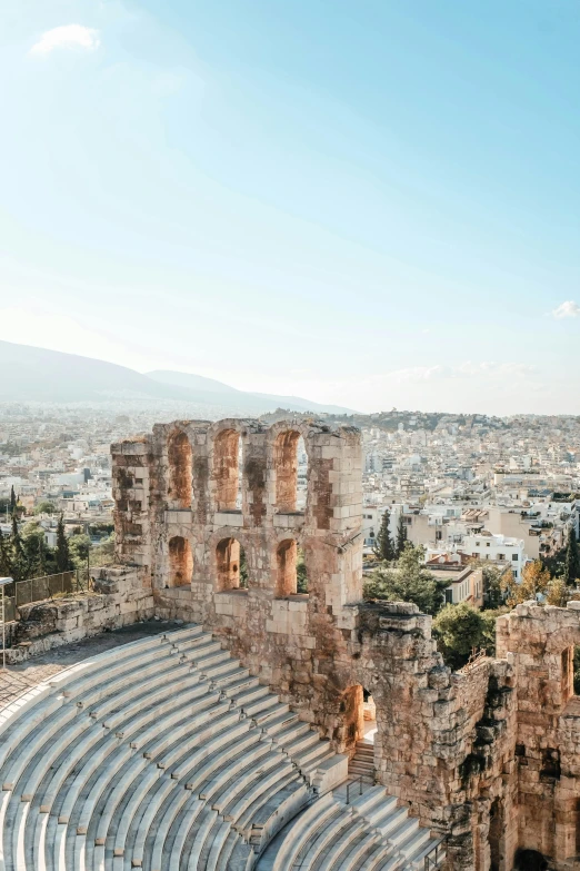 an outdoor theatre sits among the ruins of an old greek city