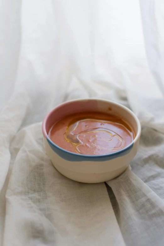 a bowl of soup on a beige cloth