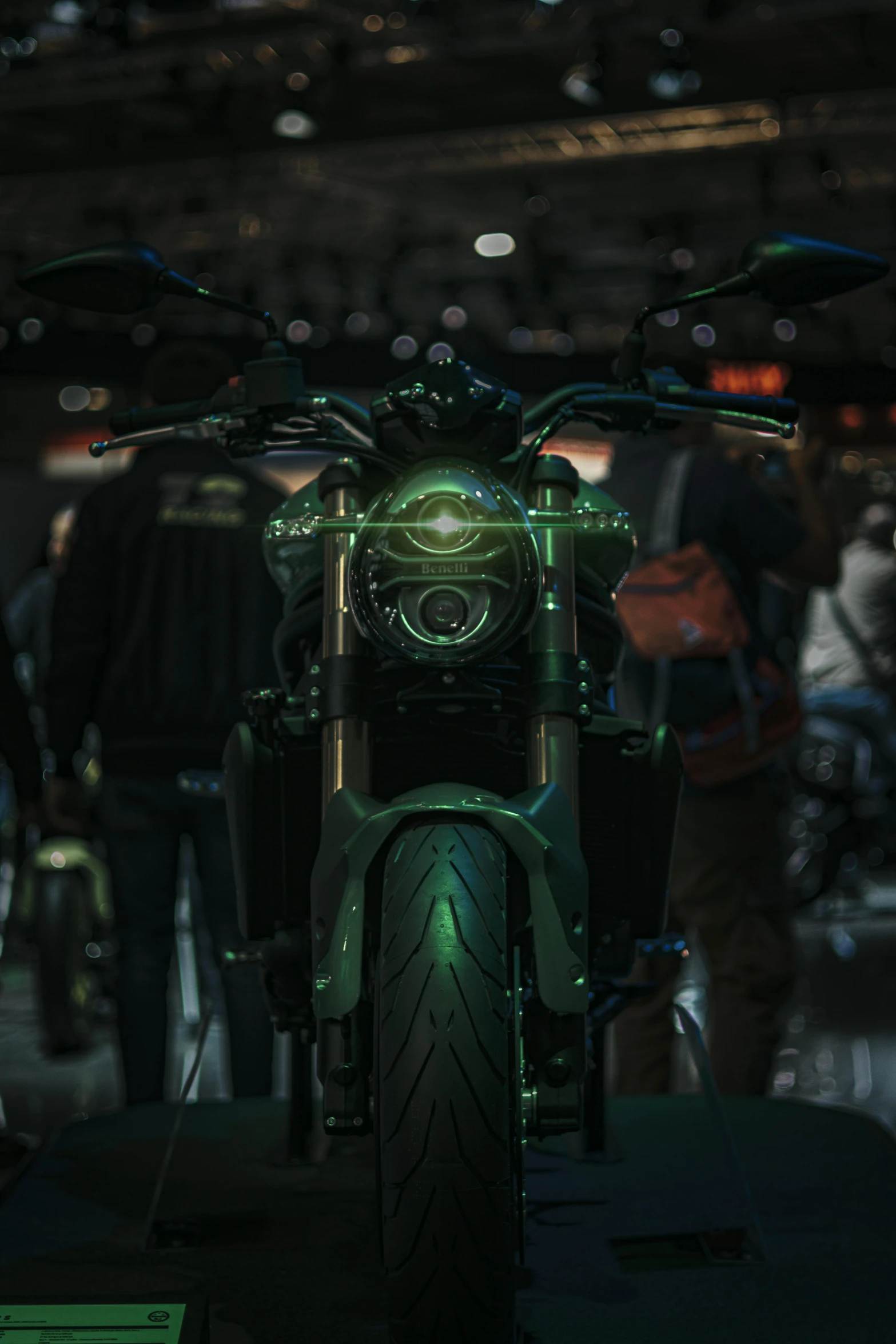 motorcycle with green lights parked in a dark room