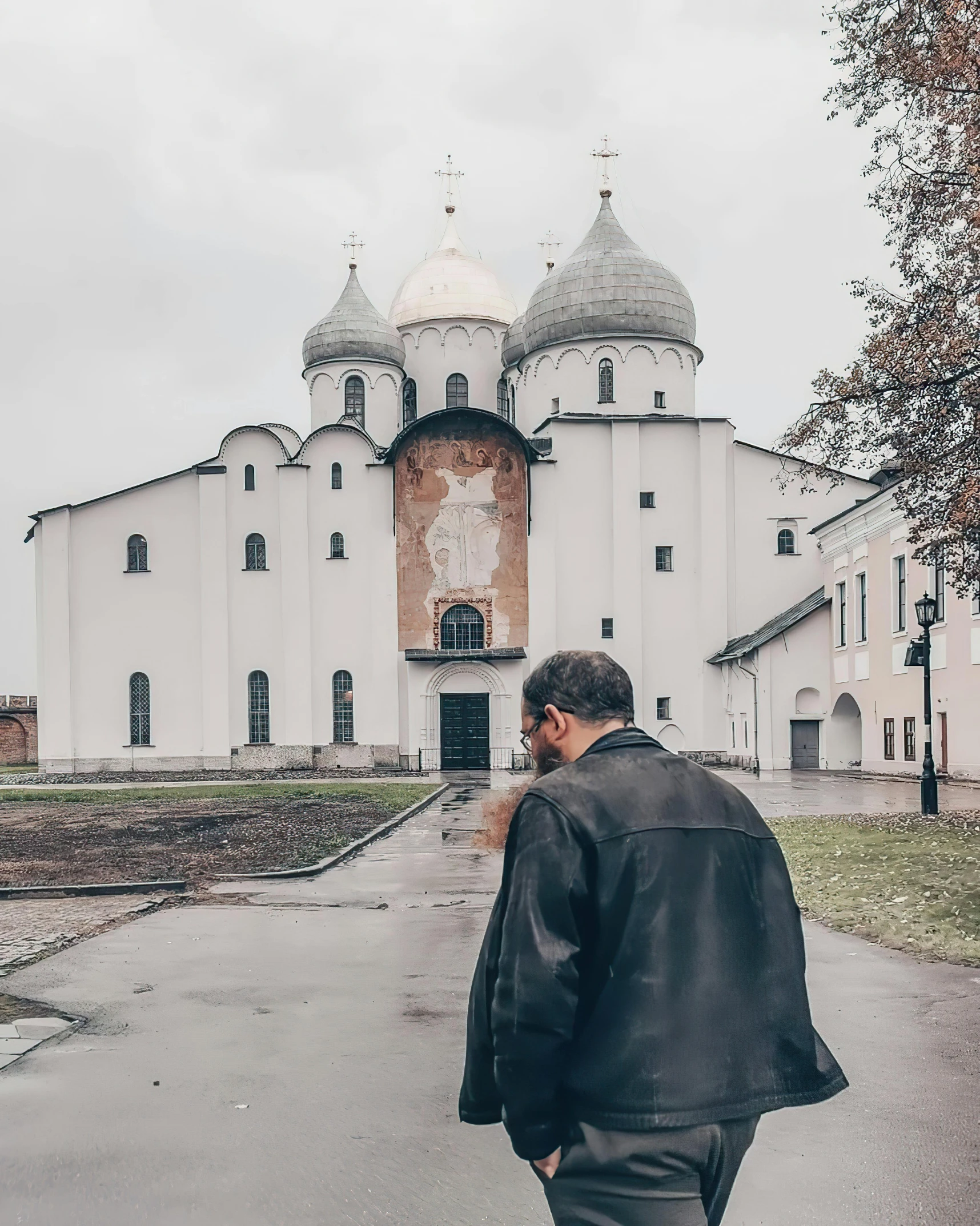 a man standing outside a building in a park