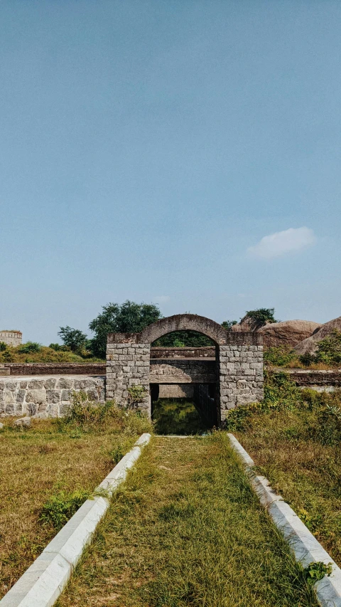 a grassy hill that has some concrete structures on it