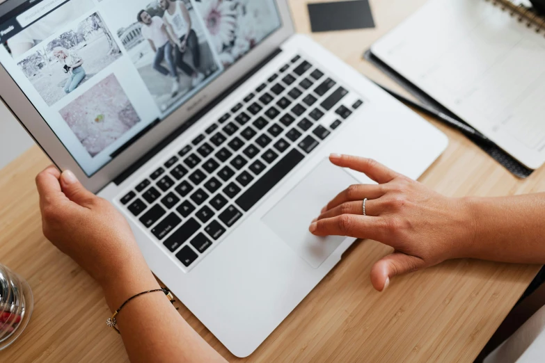 a woman with her hands on a laptop