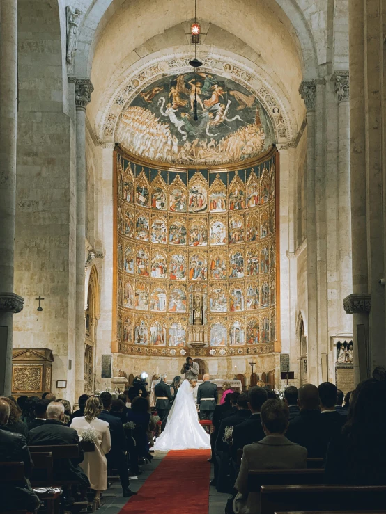 a wedding picture taken at the back of the church aisle