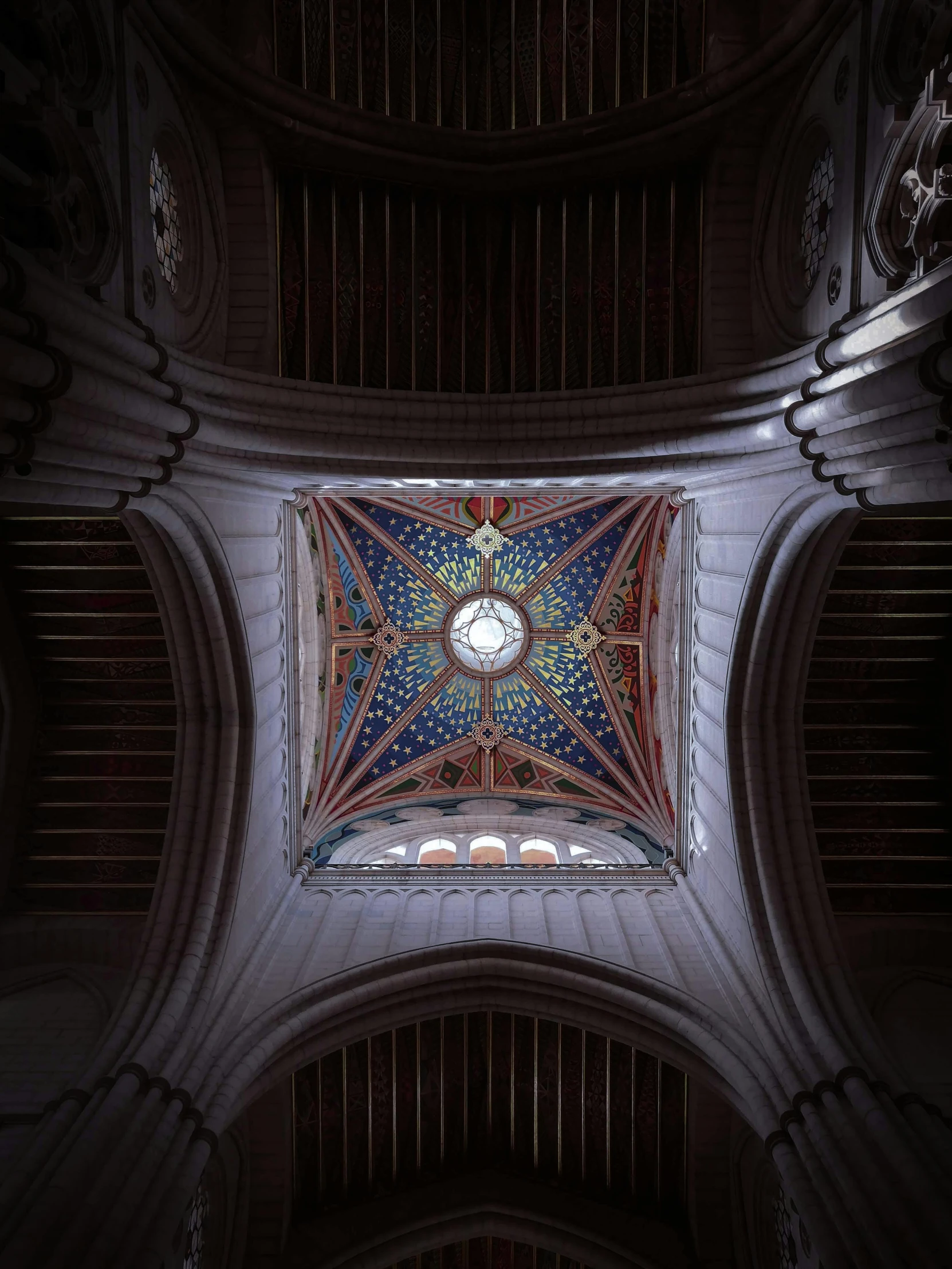 the ceiling in a large cathedral with a clock above it