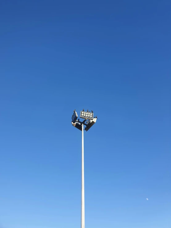 there is a flag pole and an american flag in the sky