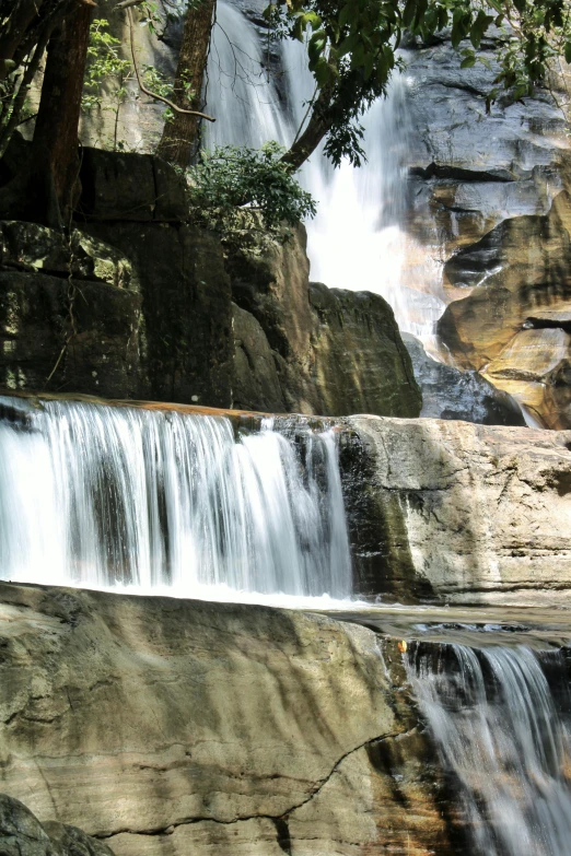 the waterfall at the foot of the mountains has water flowing from it