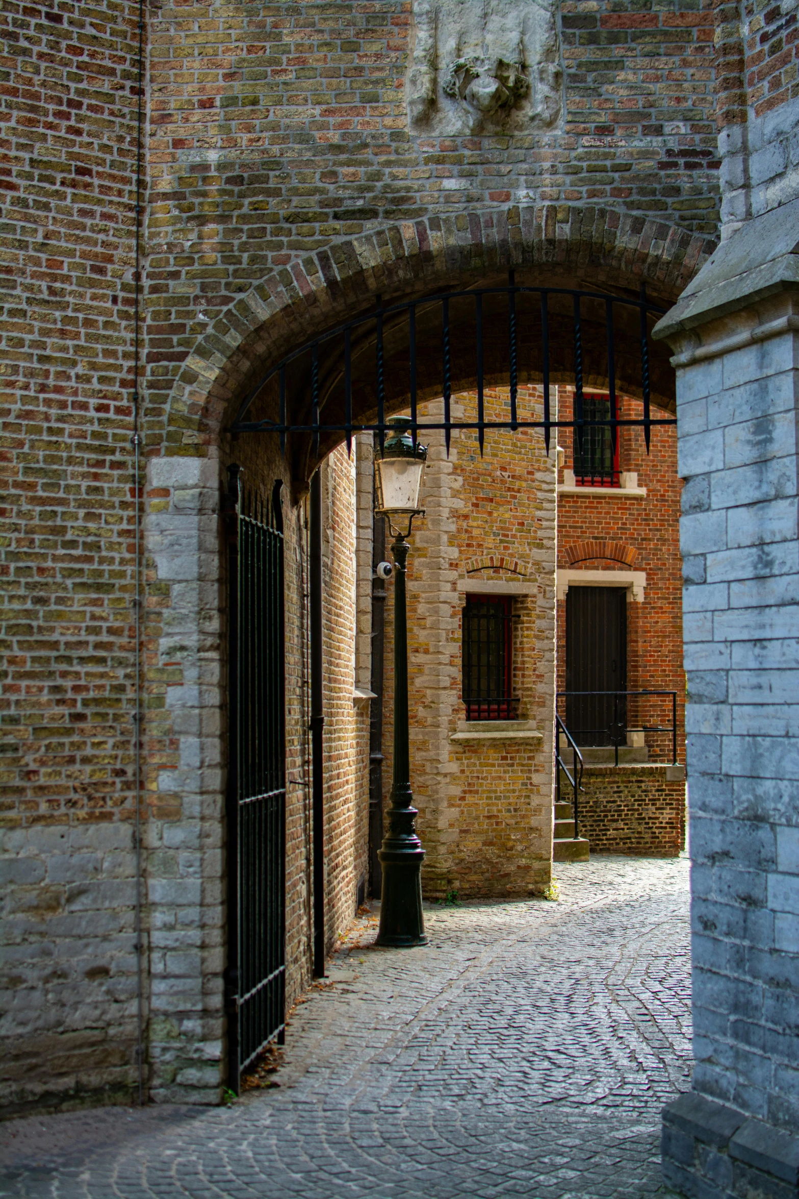 an arched doorway leading into a brick building