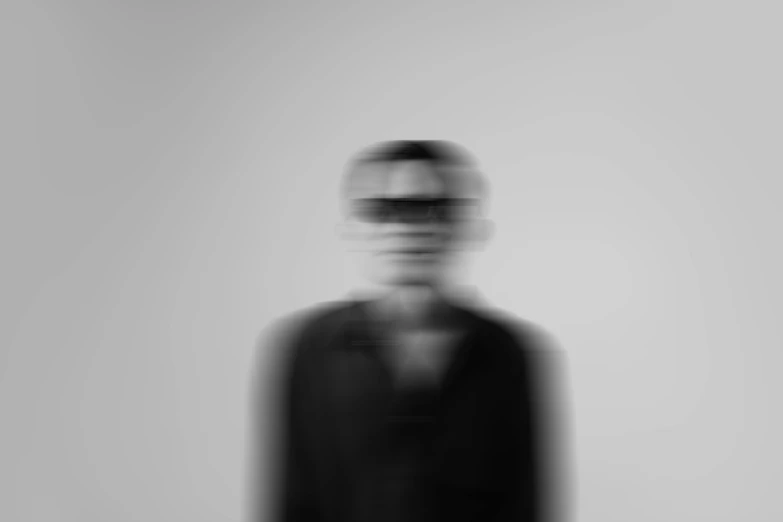 blurry pograph of a man wearing black in a coat