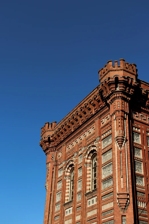 a tall brick building has ornamental architecture