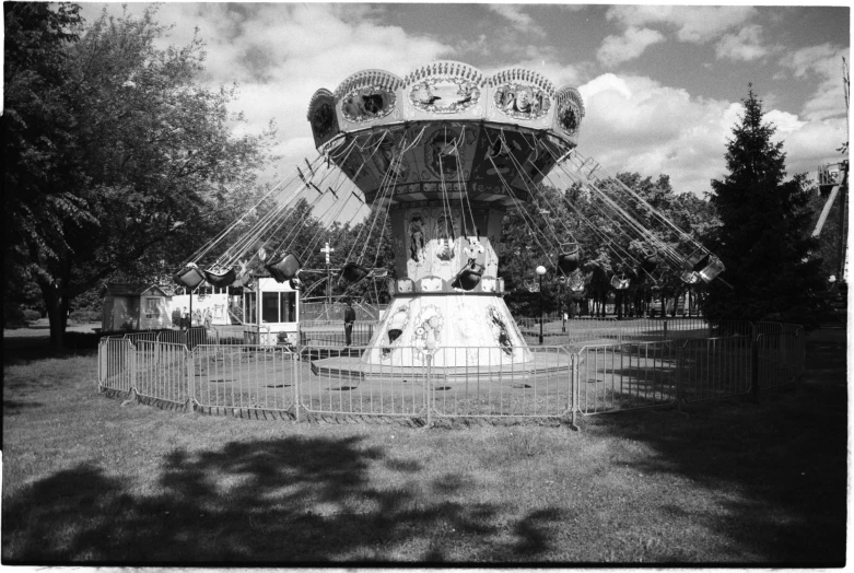 a carousel ride in an empty park near the ground