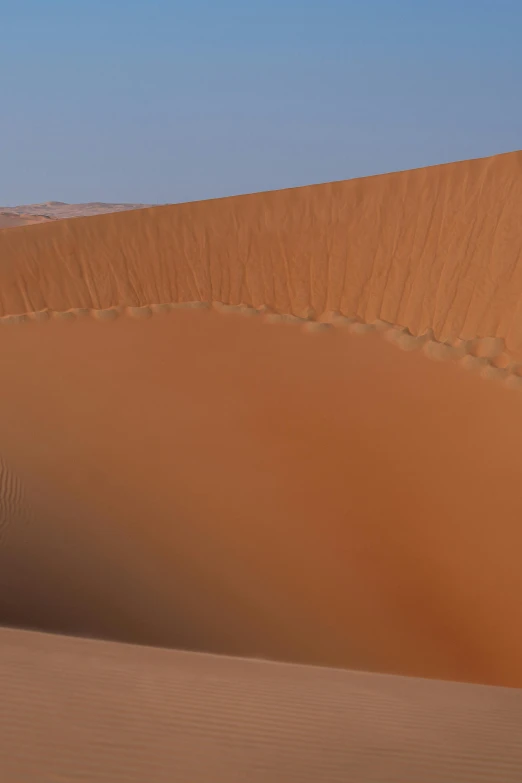 a man riding a horse over sand in the sahara