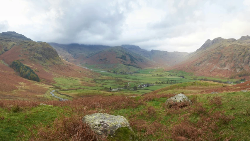 a landscape po of mountains and plains with green grass