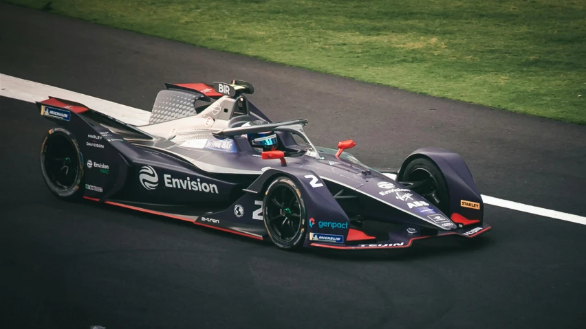 a formula car driving down the road in a racing course