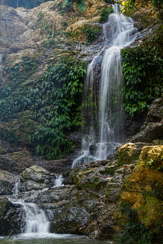 there is a waterfall on the side of the cliff