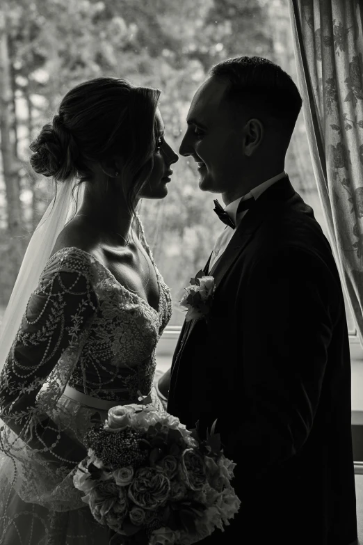 bride and groom share an intimate moment by the window