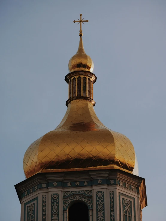 the top of a tall building has a gold steeple