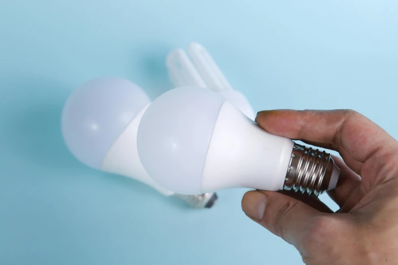 there is a light bulb with two hairclips sticking out of it