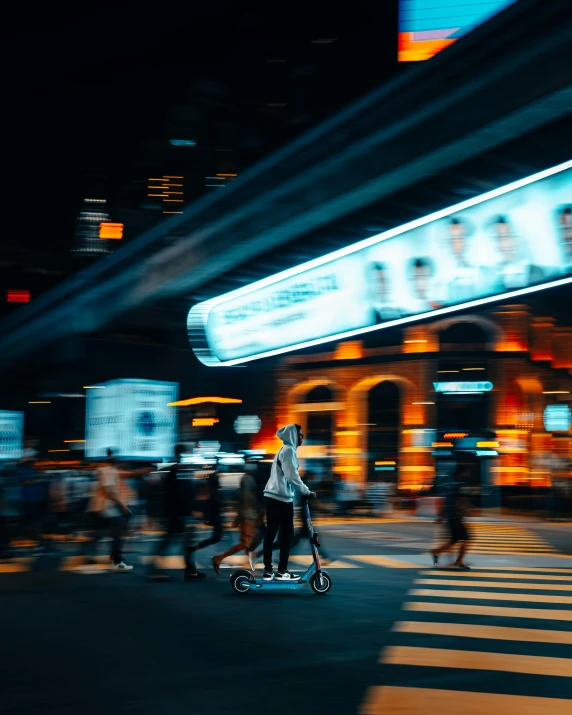 a young man riding a small skateboard in the street