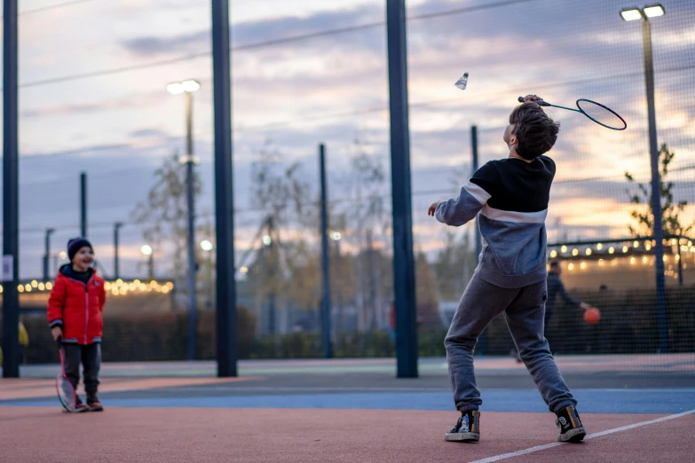 two little s playing a game of tennis