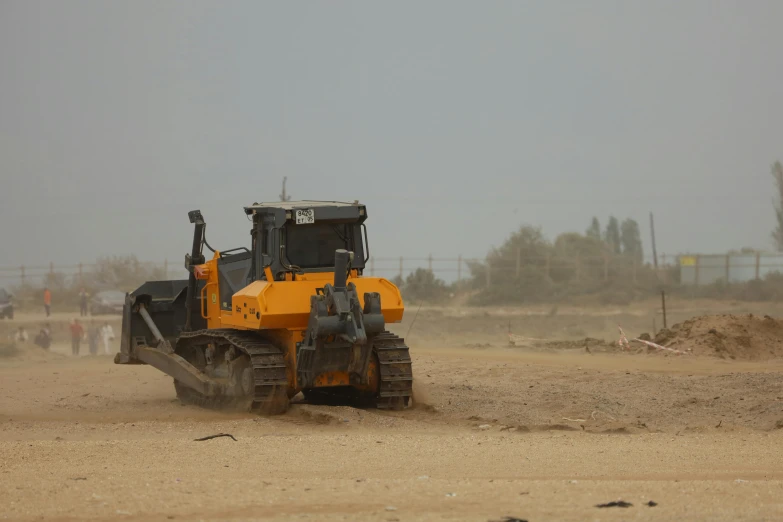 tractor with backhoes moving on open area