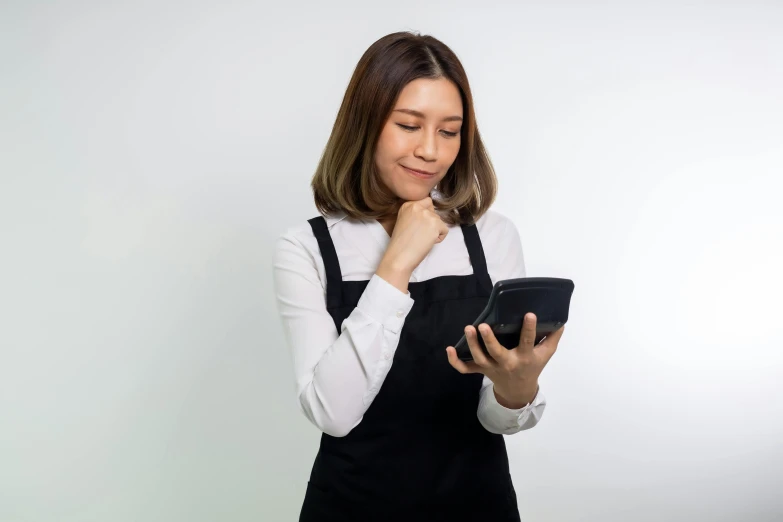 a woman with an apron is looking down at a bowl