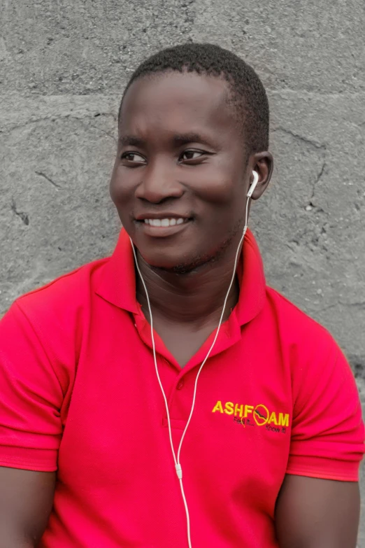 an african american man wearing headphones and red shirt