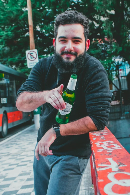 a man holding an empty beer bottle in his hand