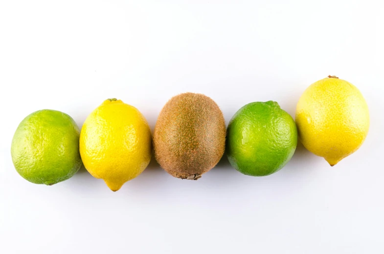 seven limes and a lemon sit side by side