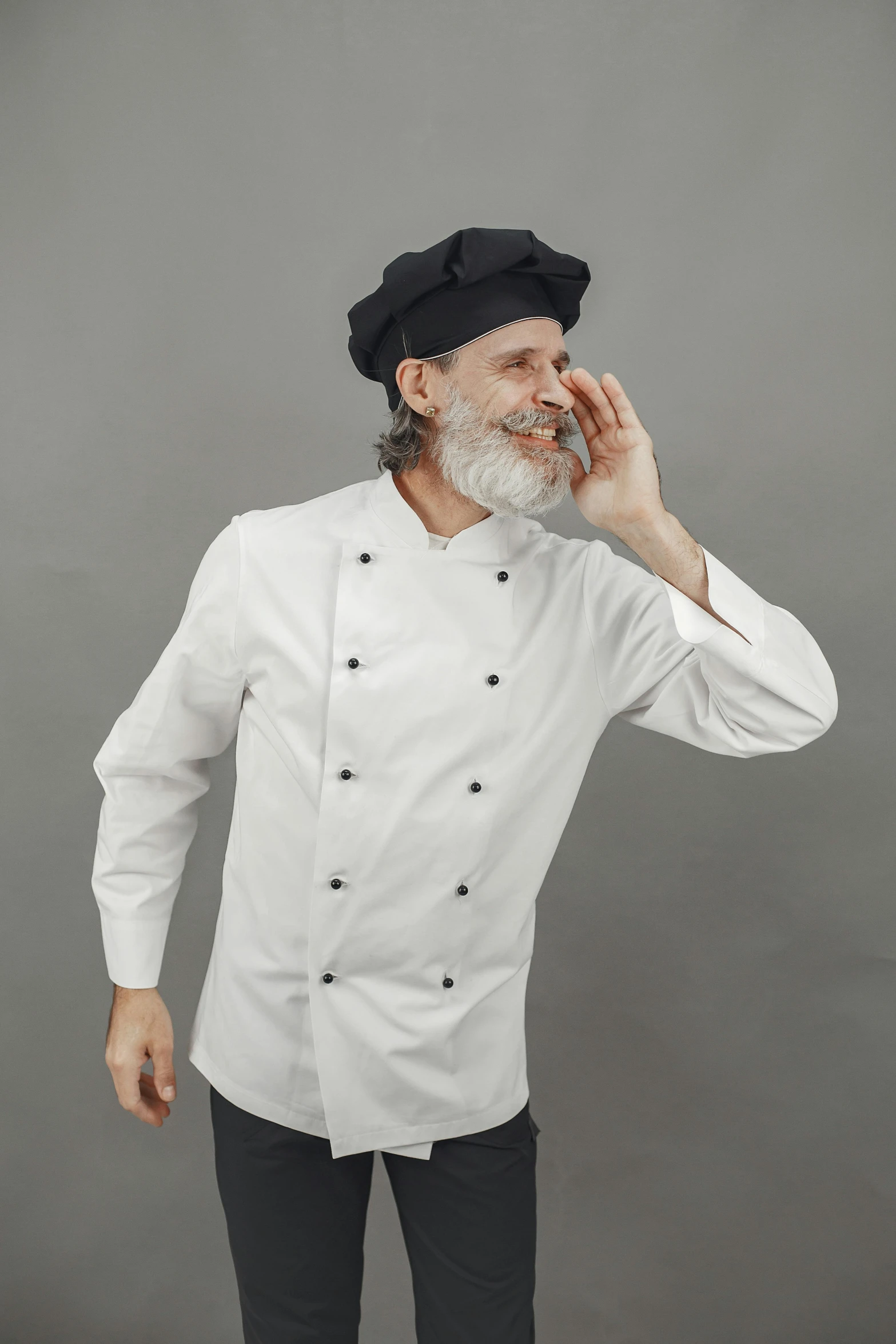 an older man with a beard wearing a white chef coat