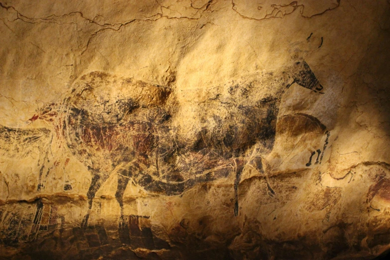 an image of some animals on a rock wall