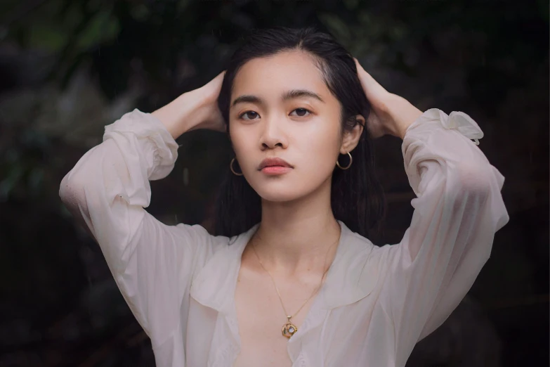 a girl posing with her head above her ears