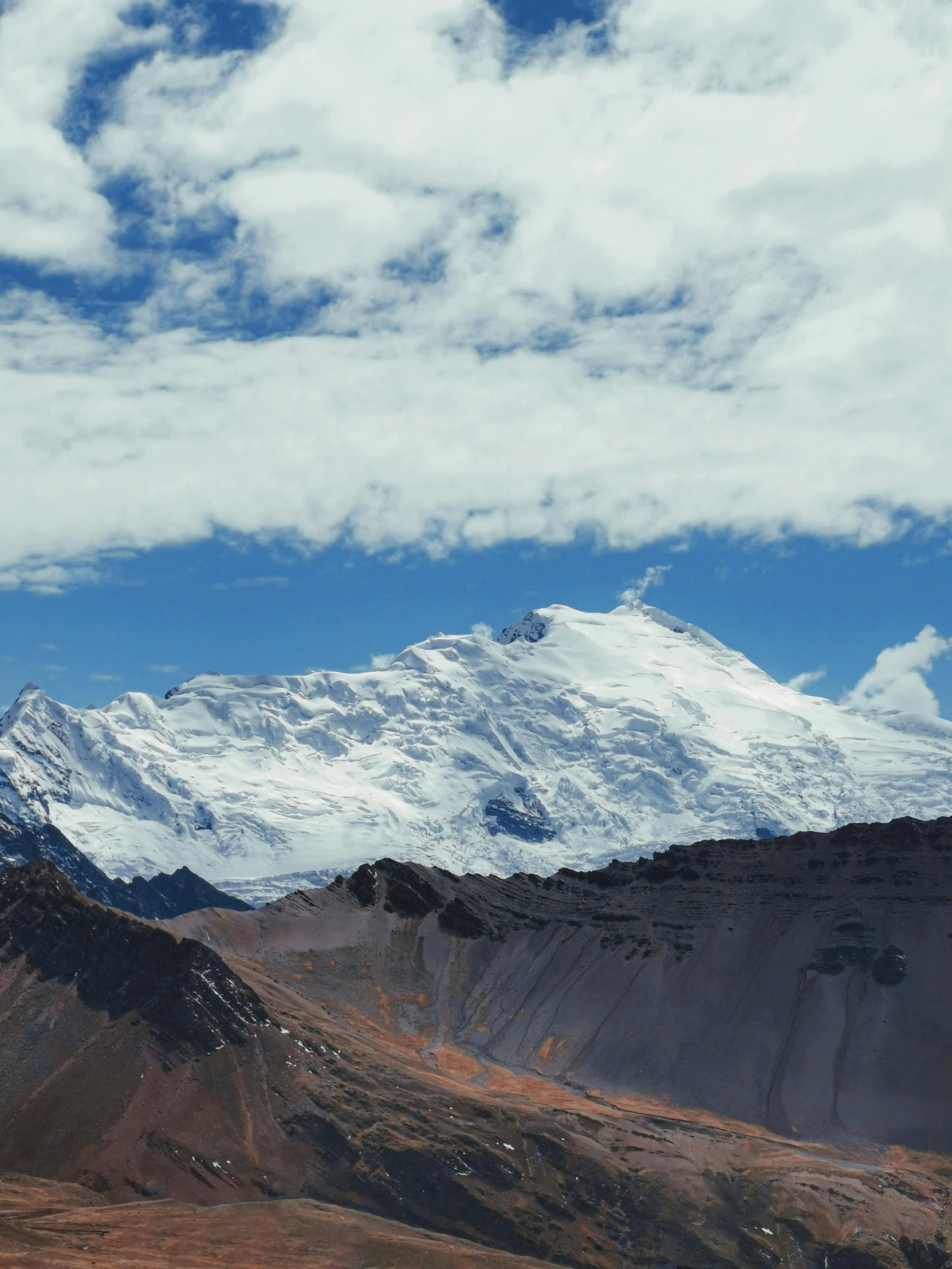 there is a mountain peak with a blue sky above