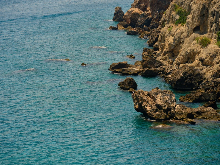 a large body of water surrounded by some rocks