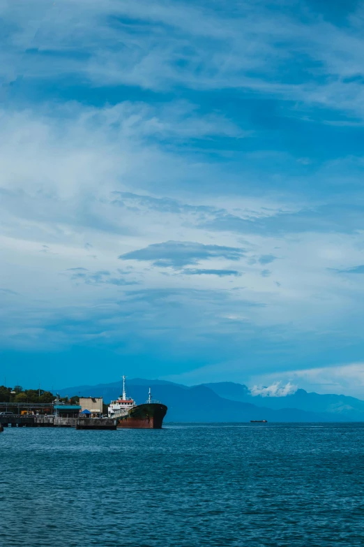 a brown and white ship floating on top of a body of water