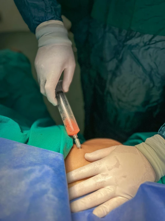 hands in gloves work with a needled in patient