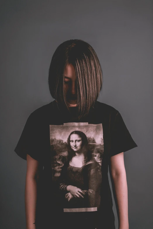 a  with a t - shirt showing a po of a mona tee