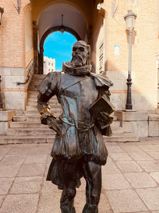 a statue in front of a brick archway