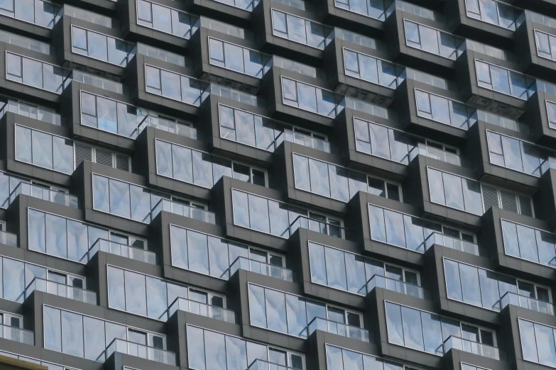 the side of an abstract building has many windows