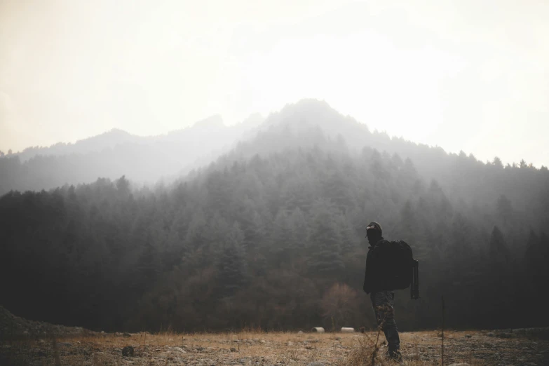 a person standing in the middle of a field